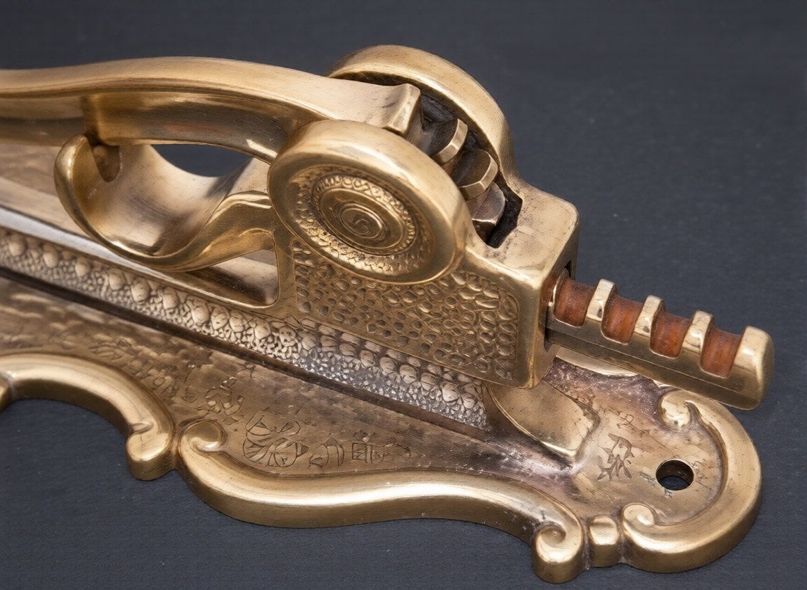 Brass wall-mounted wine bottleopener